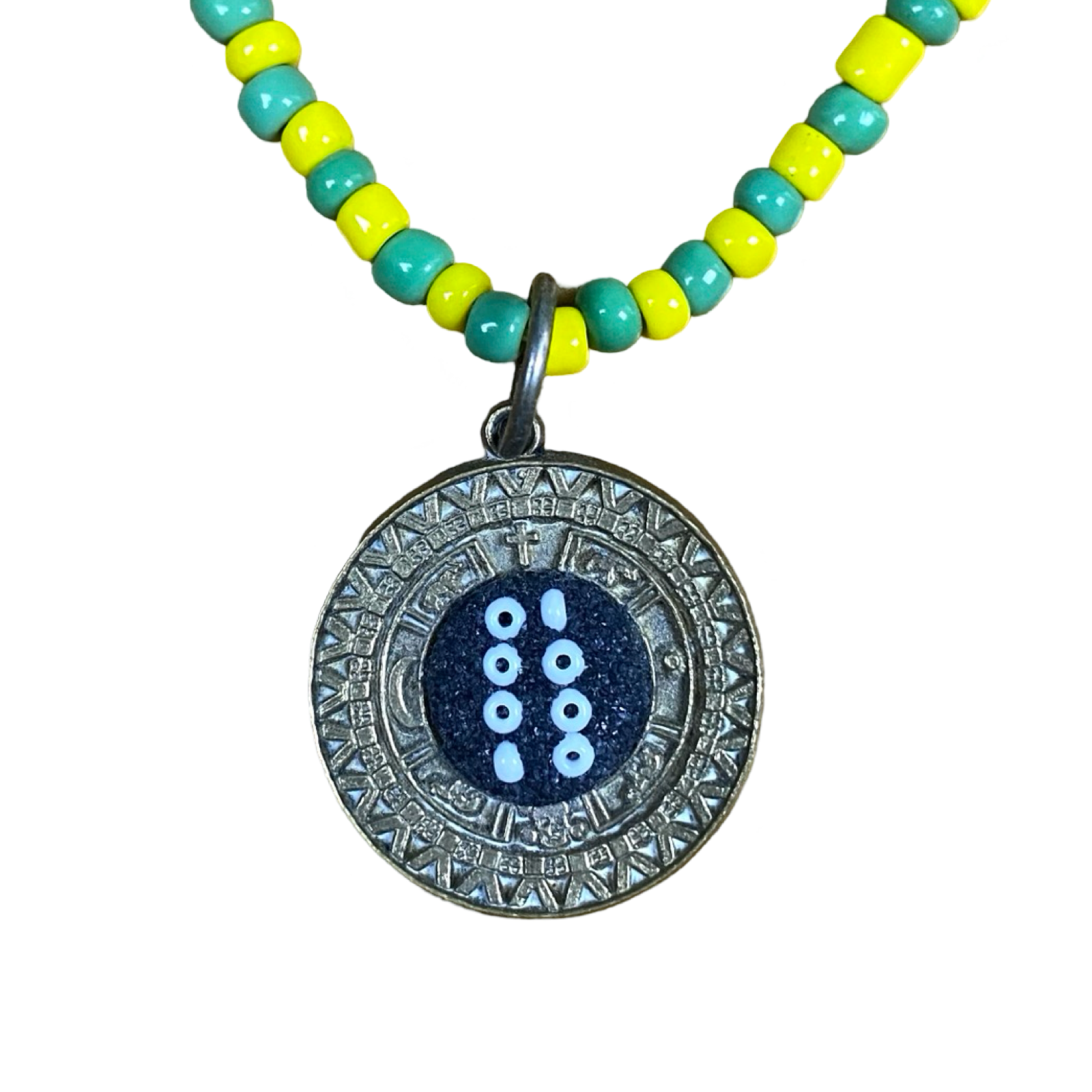 Close-up of the Tablerito de Orula pendant showing intricate round design.
