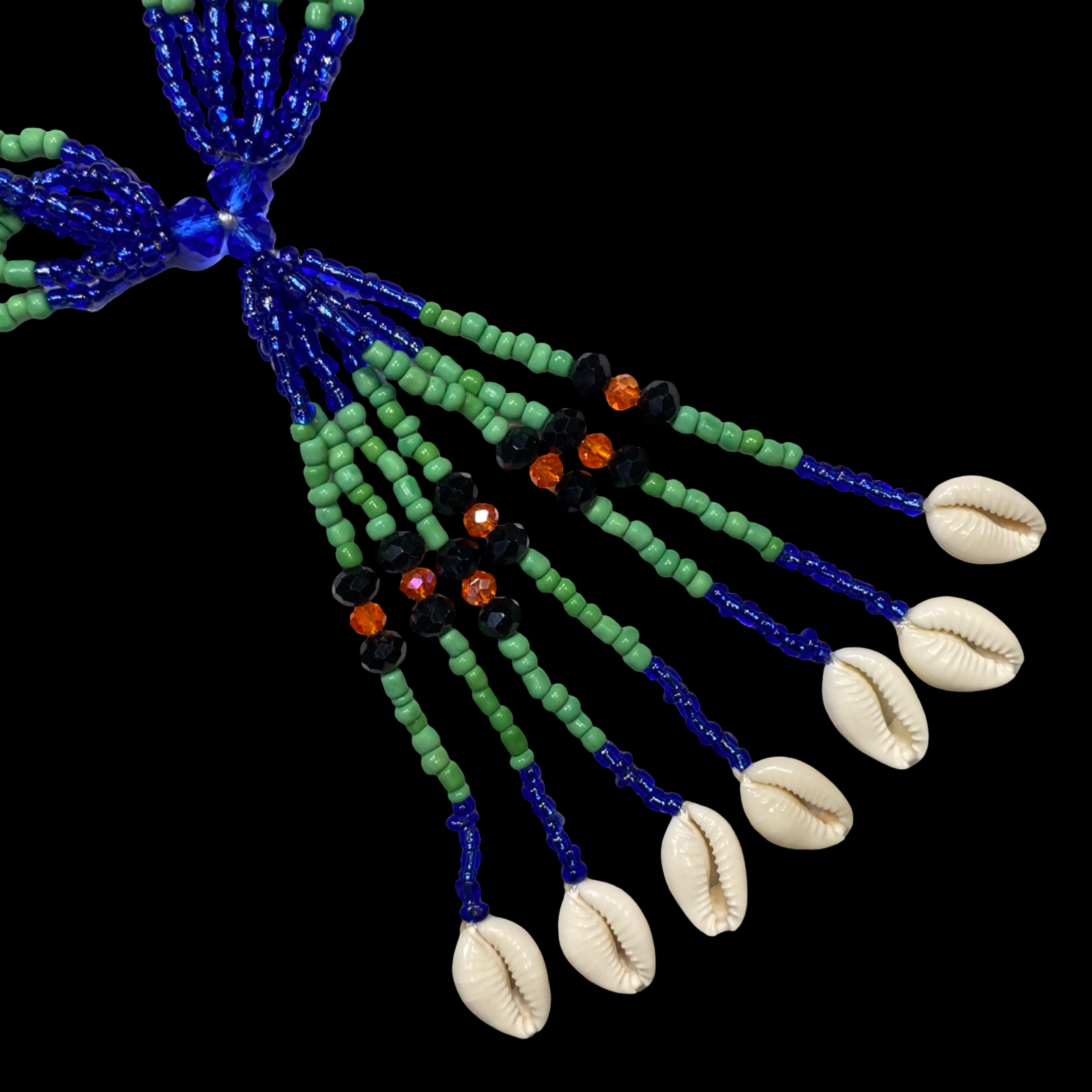 A beaded crystal mazo (scepter) with turquoise, green, and white beads, and decorations including fish, leaf, and tool charms, with braided cords.